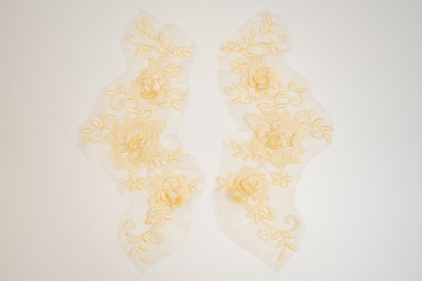 Decorative yellow floral lace on a white background