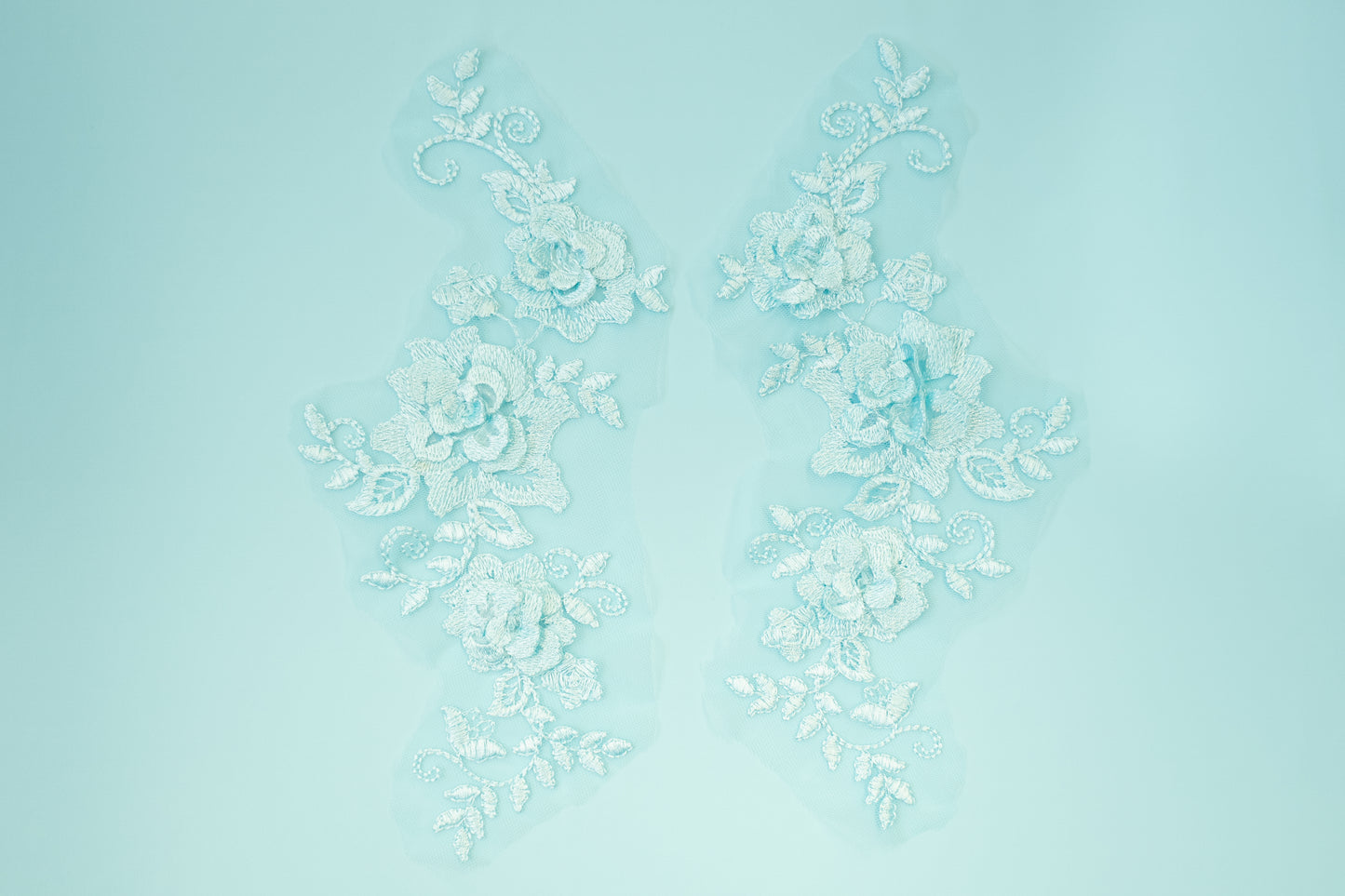 Decorative white floral pattern on a light blue background