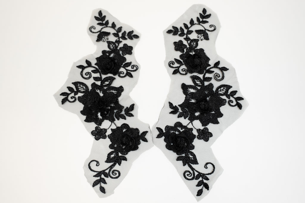 Black floral lace designs on white background