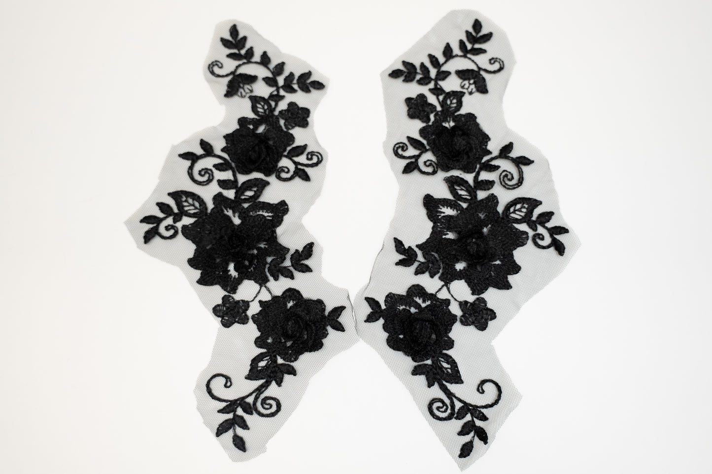Black floral lace designs on white background