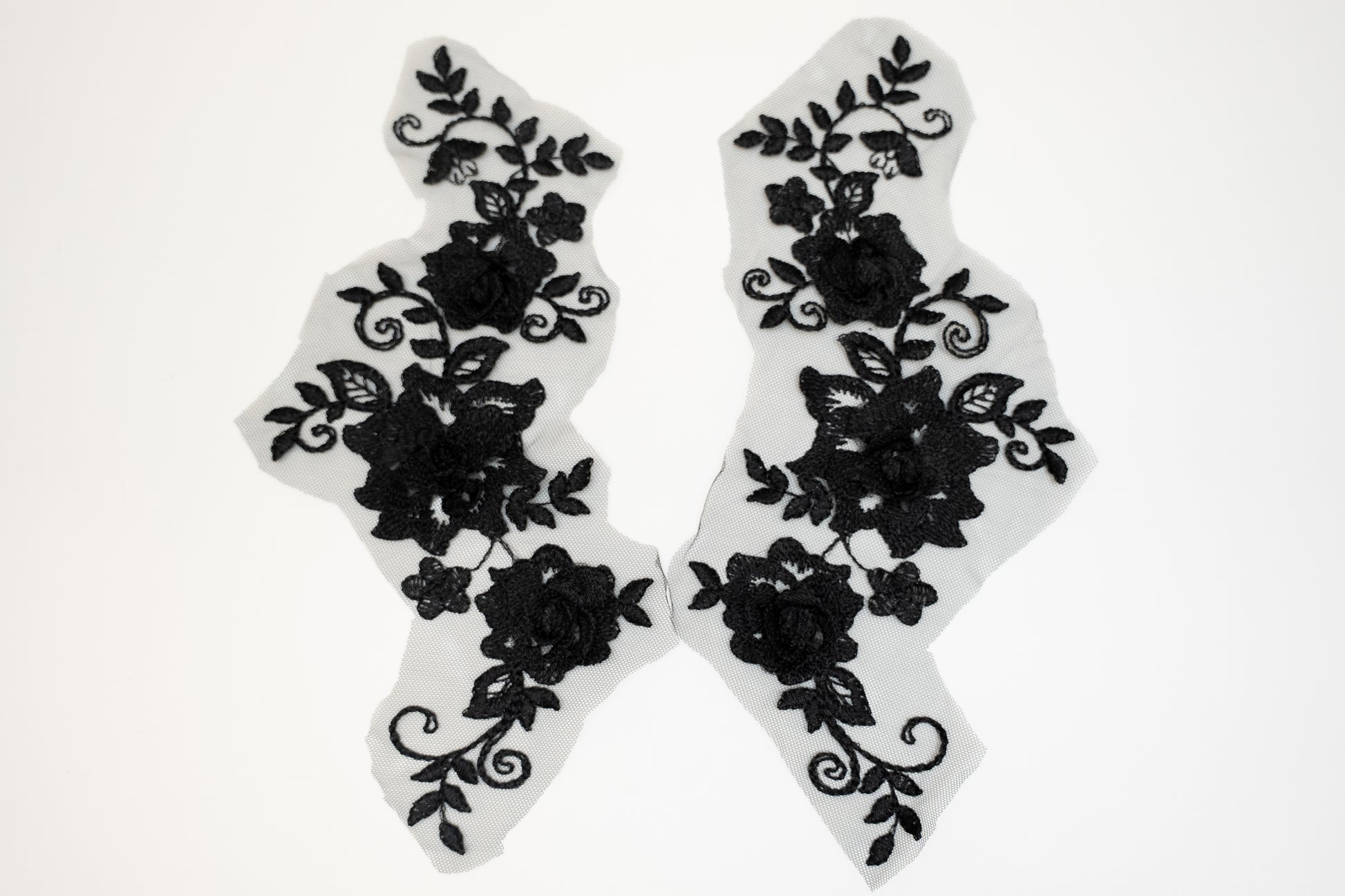 Black floral lace designs on white background