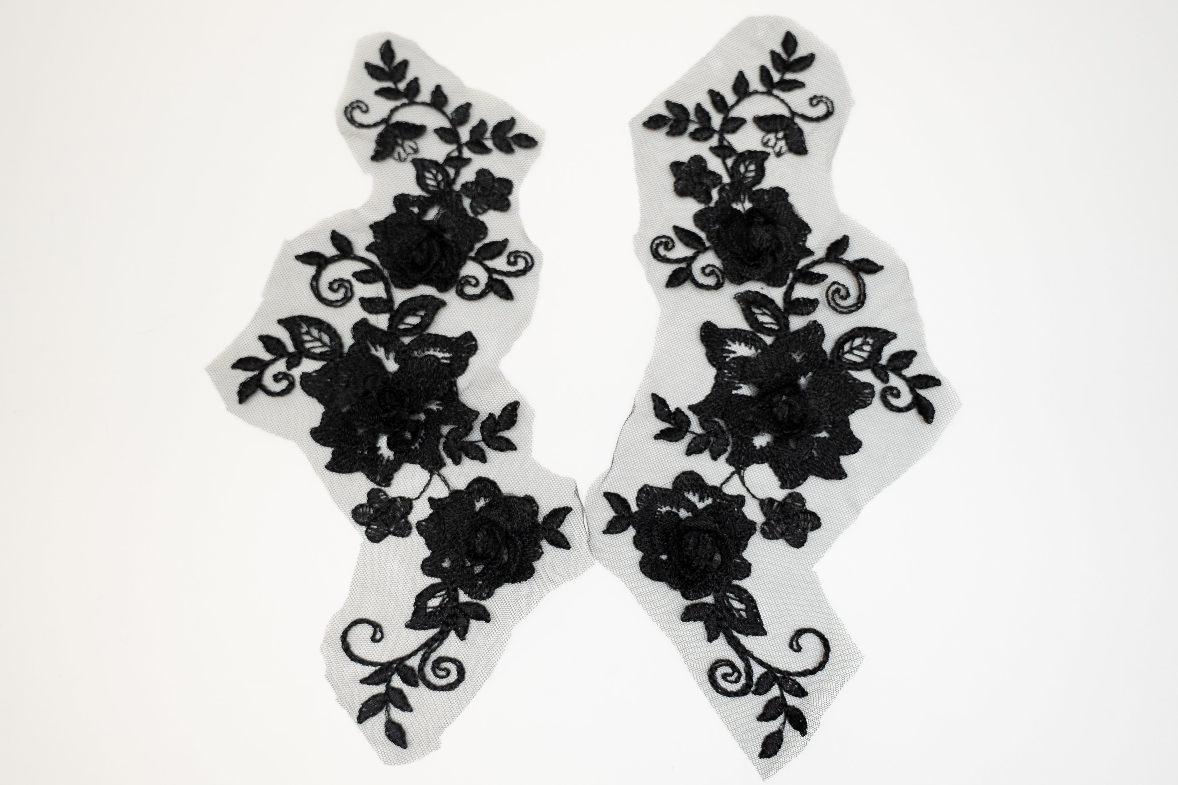 Black floral lace designs on white background
