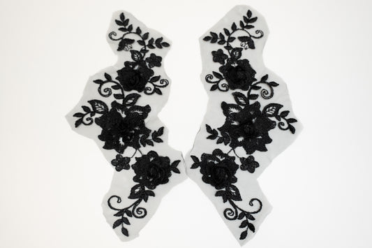 Black floral lace designs on white background