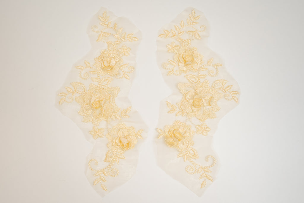 Decorative yellow floral lace on a white background