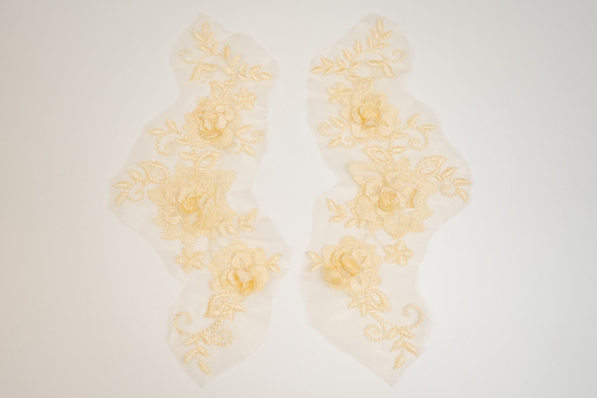 Decorative yellow floral lace on a white background