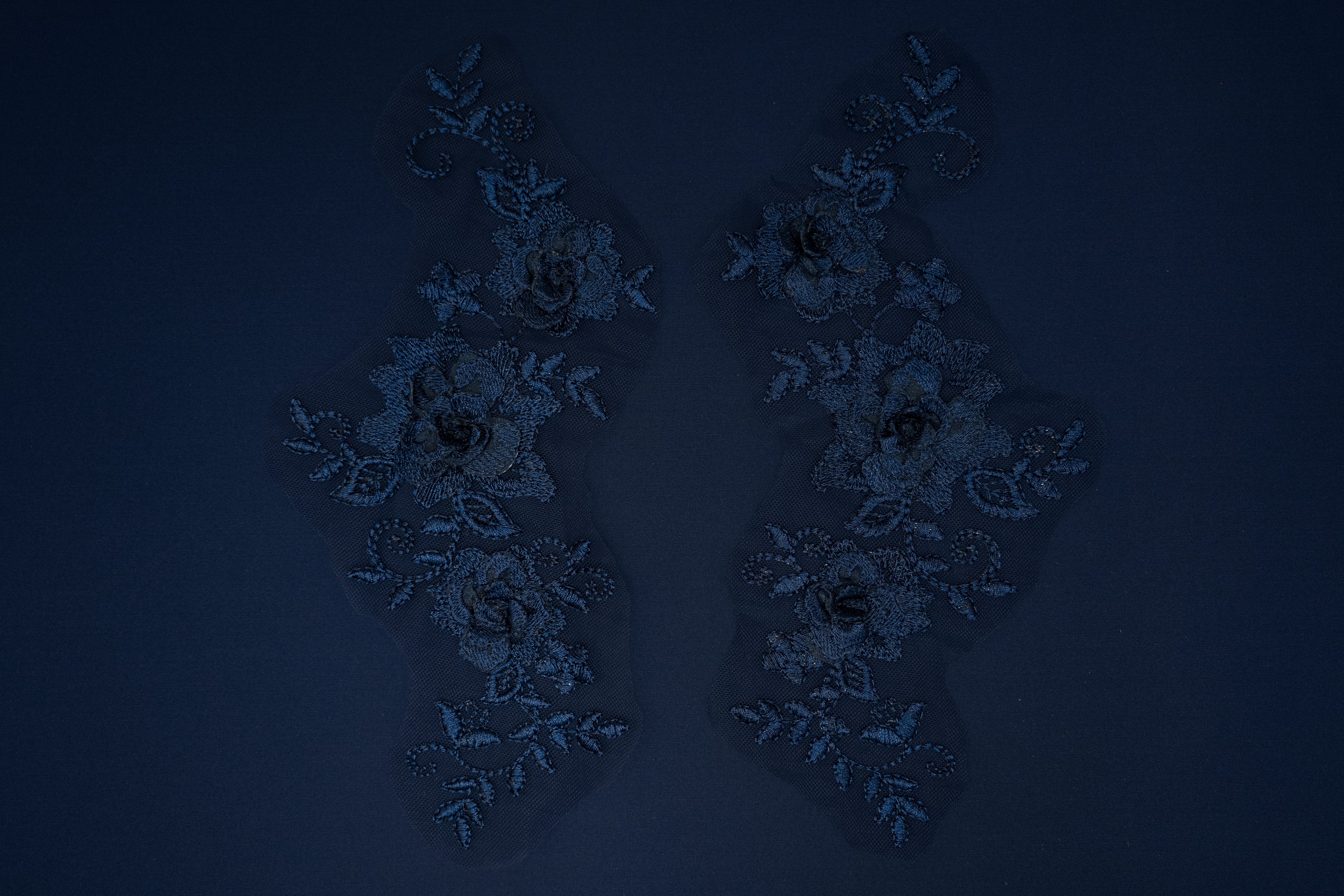 Pair of decorative earrings on a dark blue background