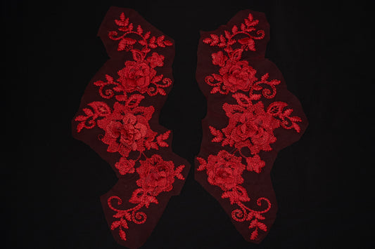 Red floral lace patches on a black background