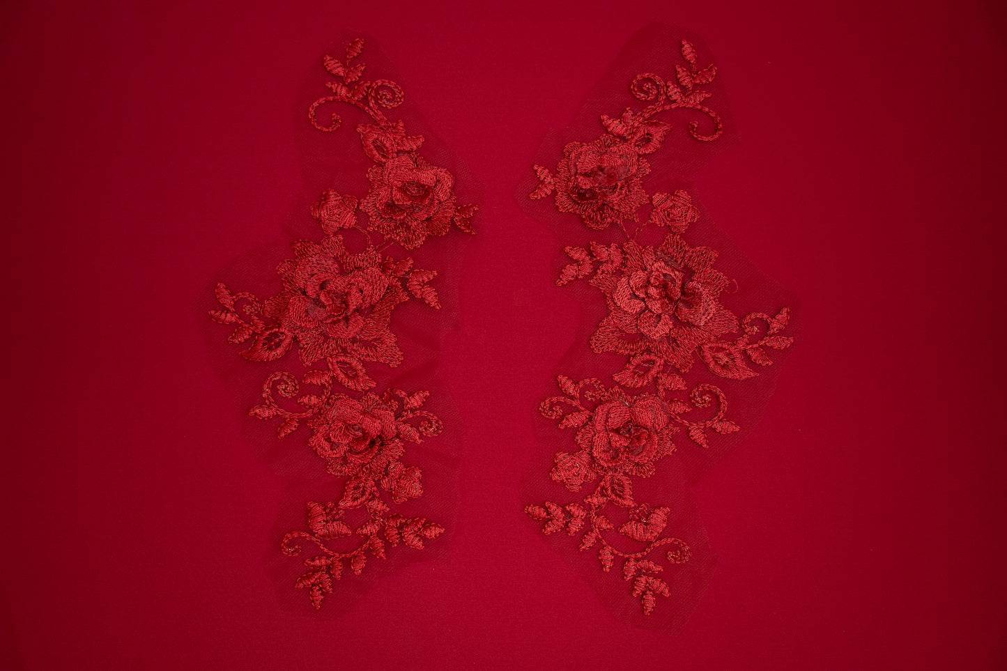 Decorative red lace patterns on a red background