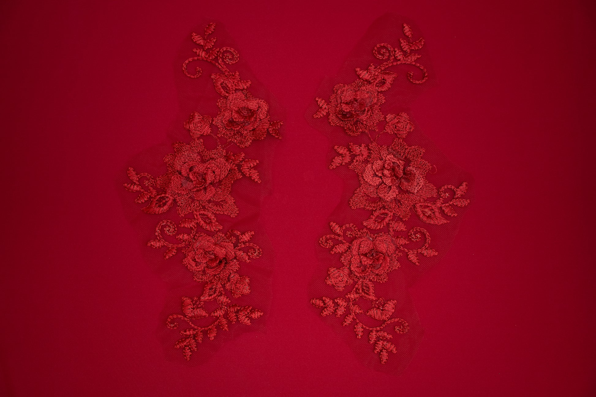 Decorative red lace patterns on a red background