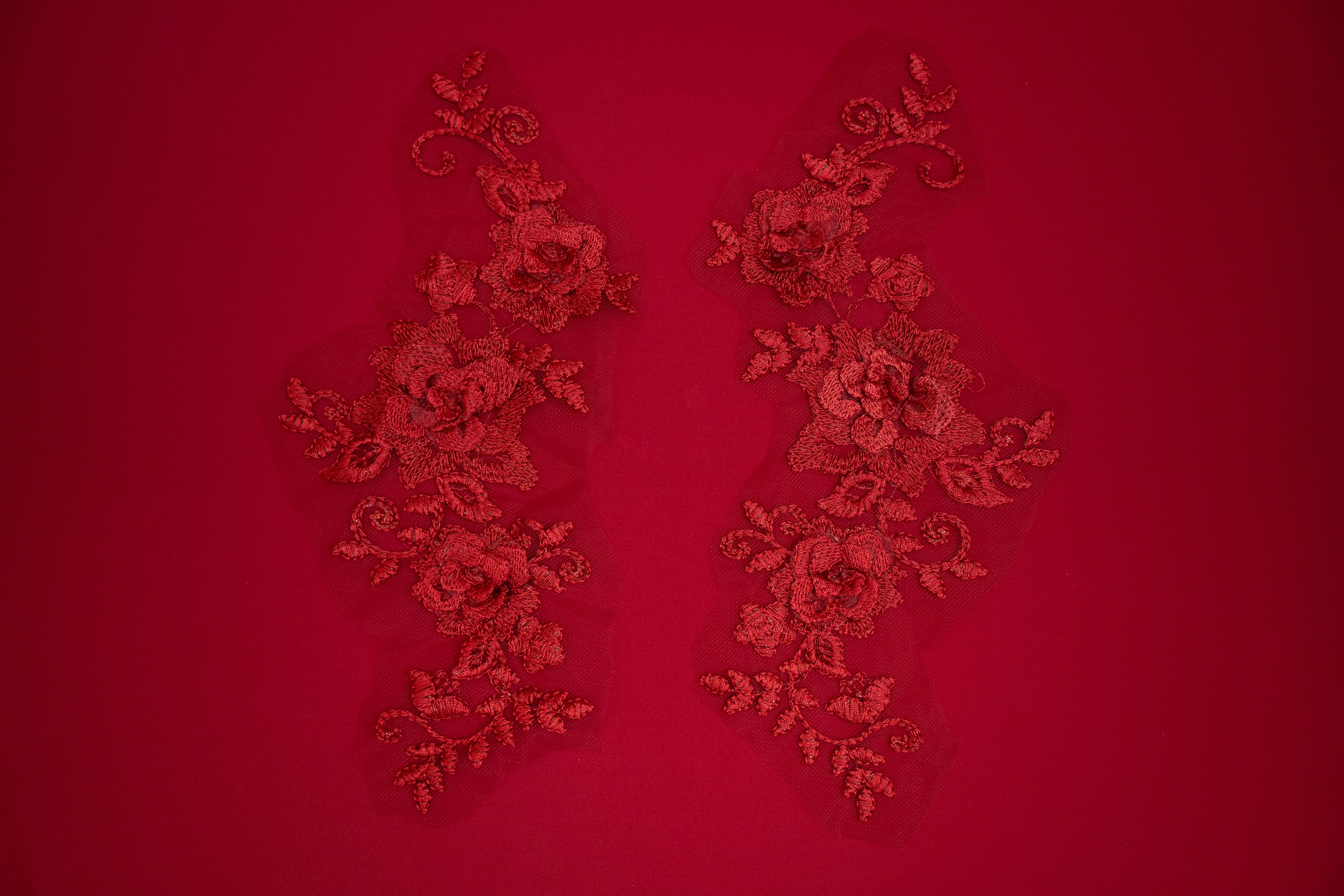 Decorative red lace patterns on a red background