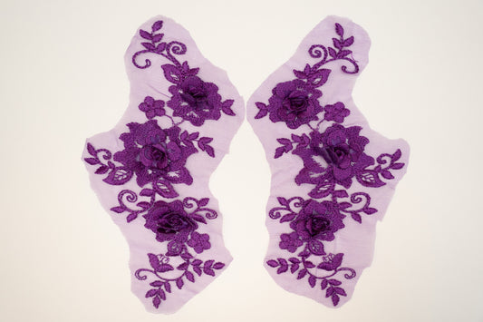 Pair of purple floral lace socks on a white background
