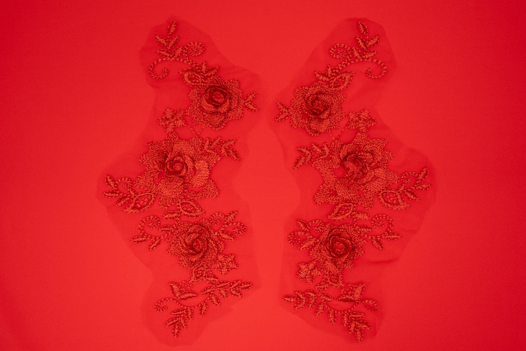 Decorative floral patches on a red background