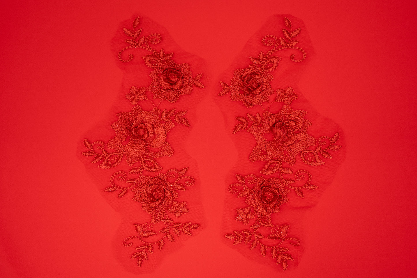 Decorative floral patches on a red background