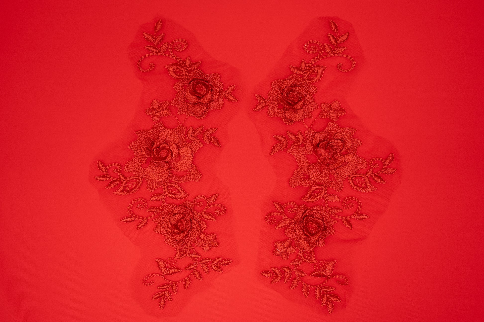 Decorative floral patches on a red background