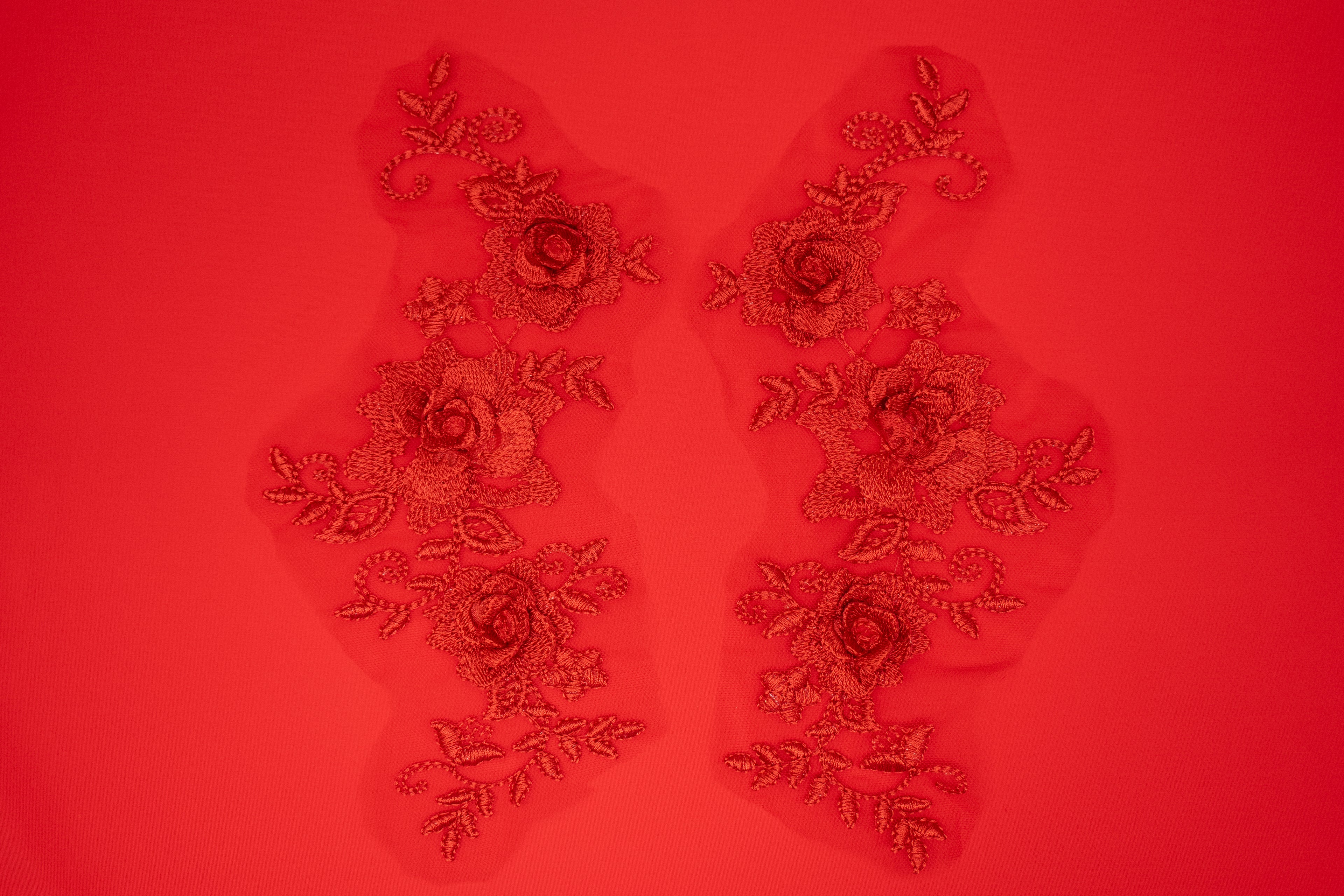 Decorative floral patches on a red background