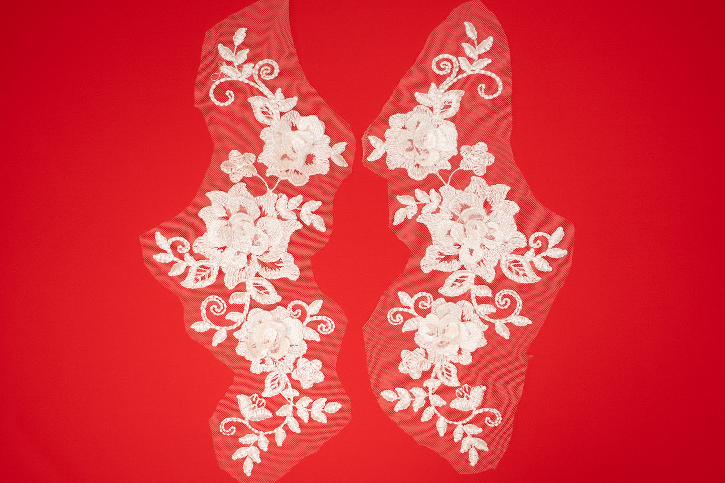 White floral lace on a red background