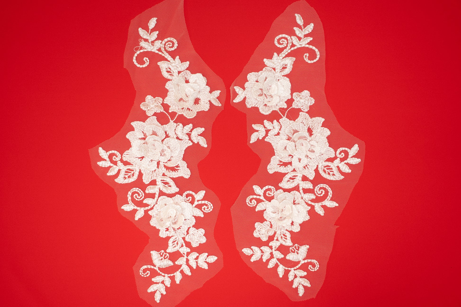 White floral lace on a red background