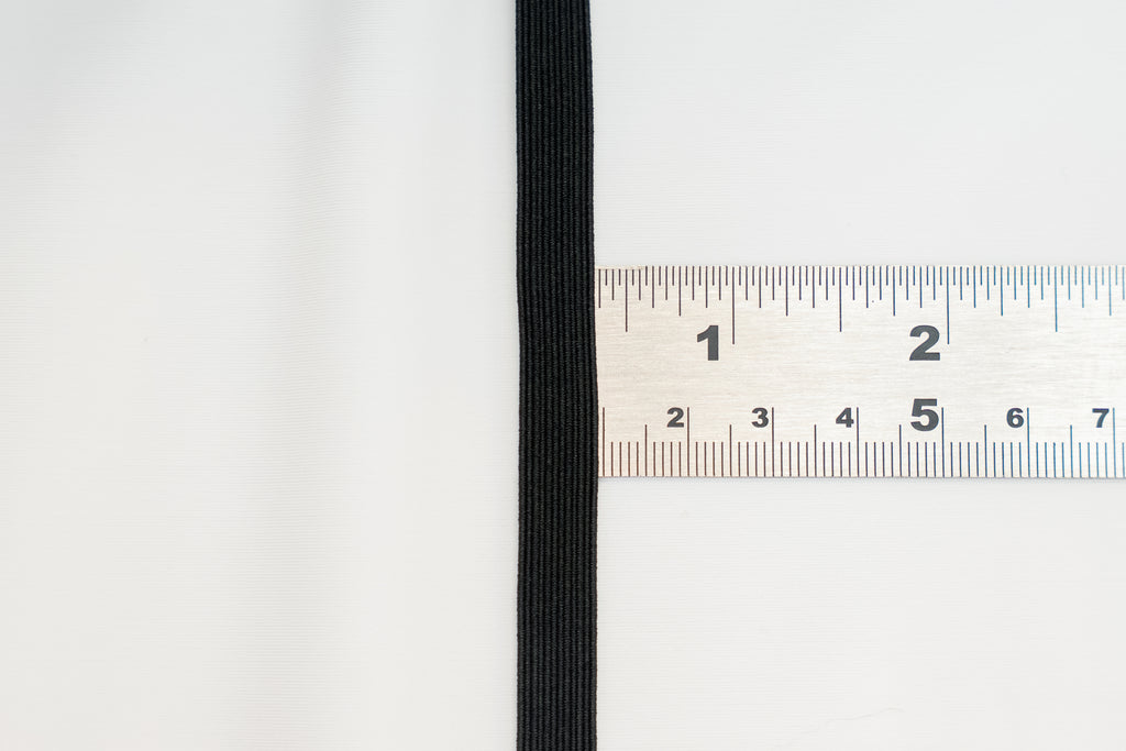 black flat braided elastic on a ruler