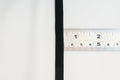 black flat braided elastic on a ruler