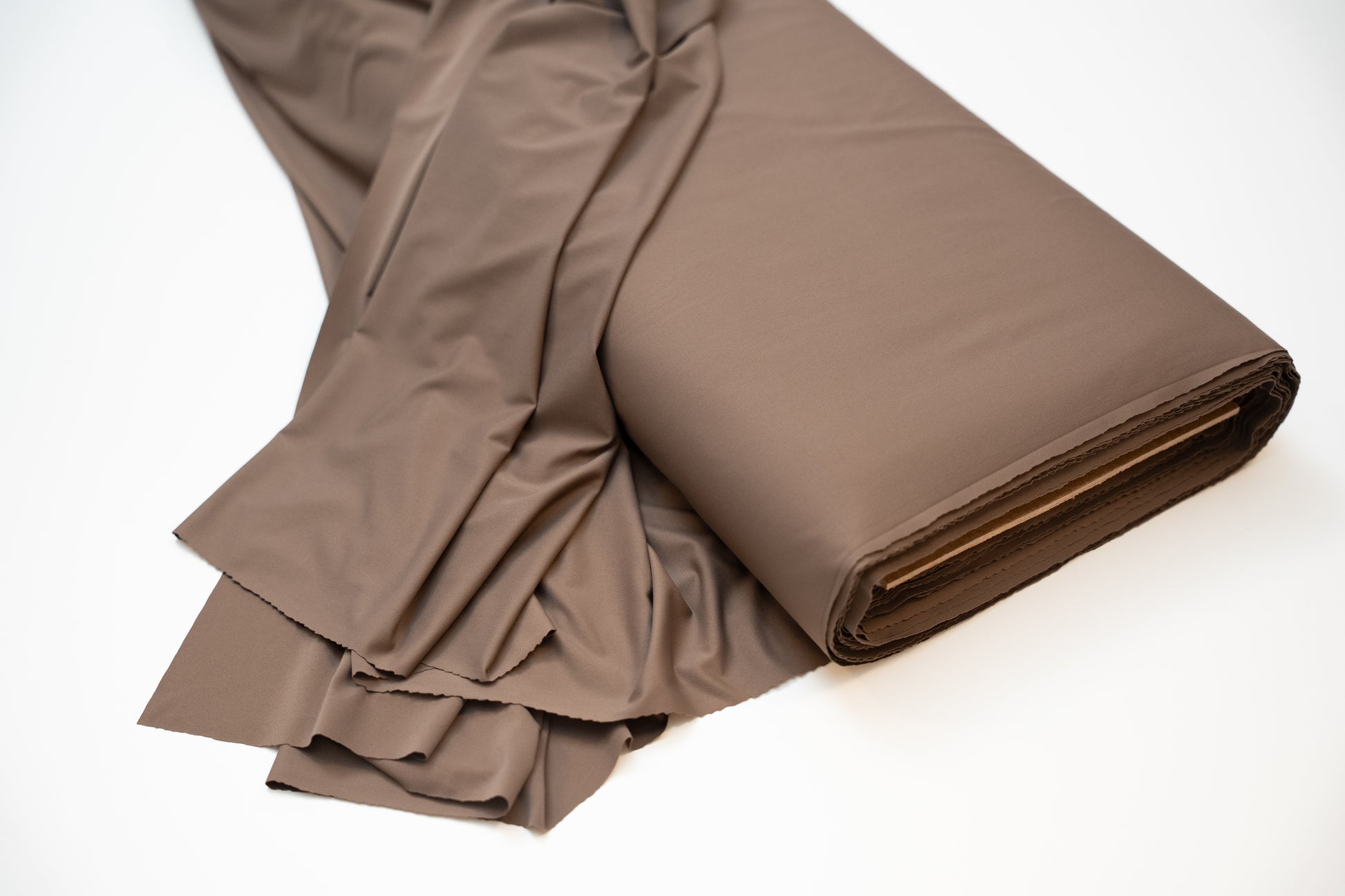 Brown fabric roll on a white background